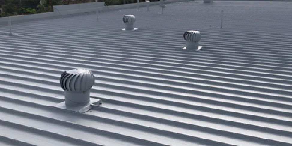 A close up of a roof with a few vents on it.