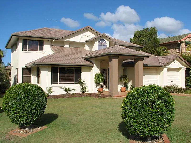 A large white house with a brown roof