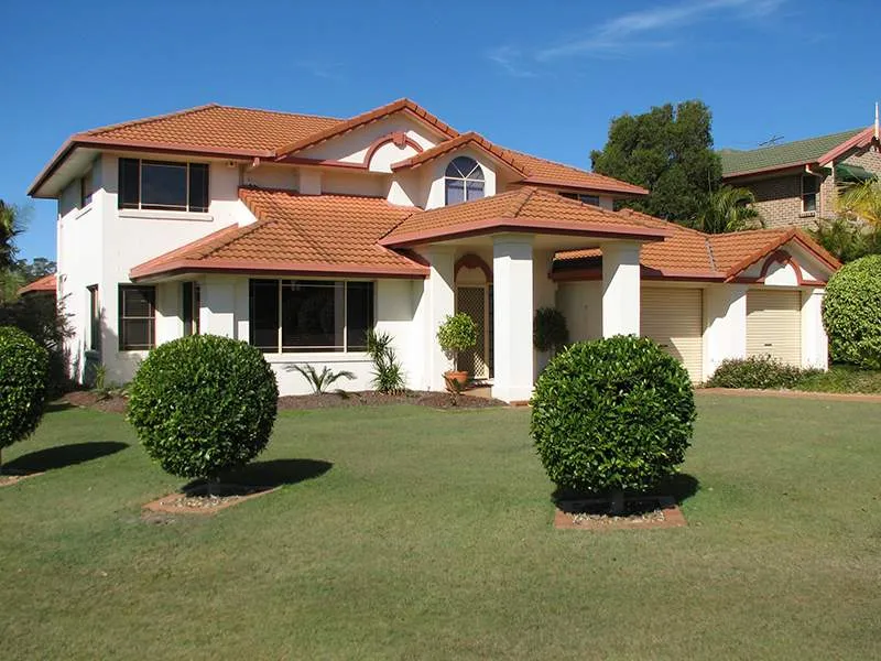 A large white house with a red tile roof
