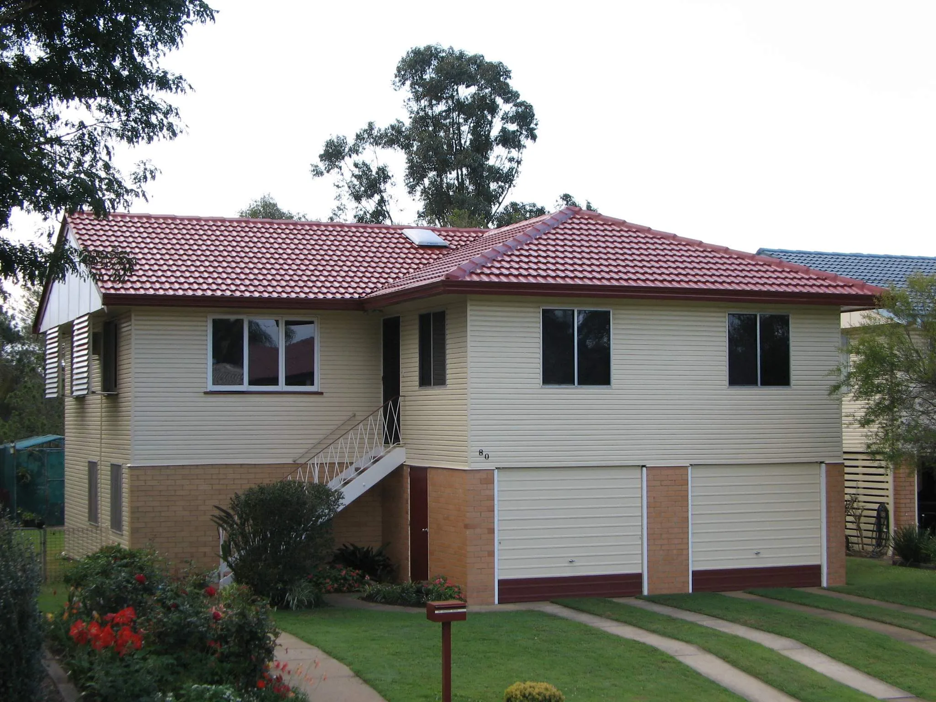 A white house with a red tile roof