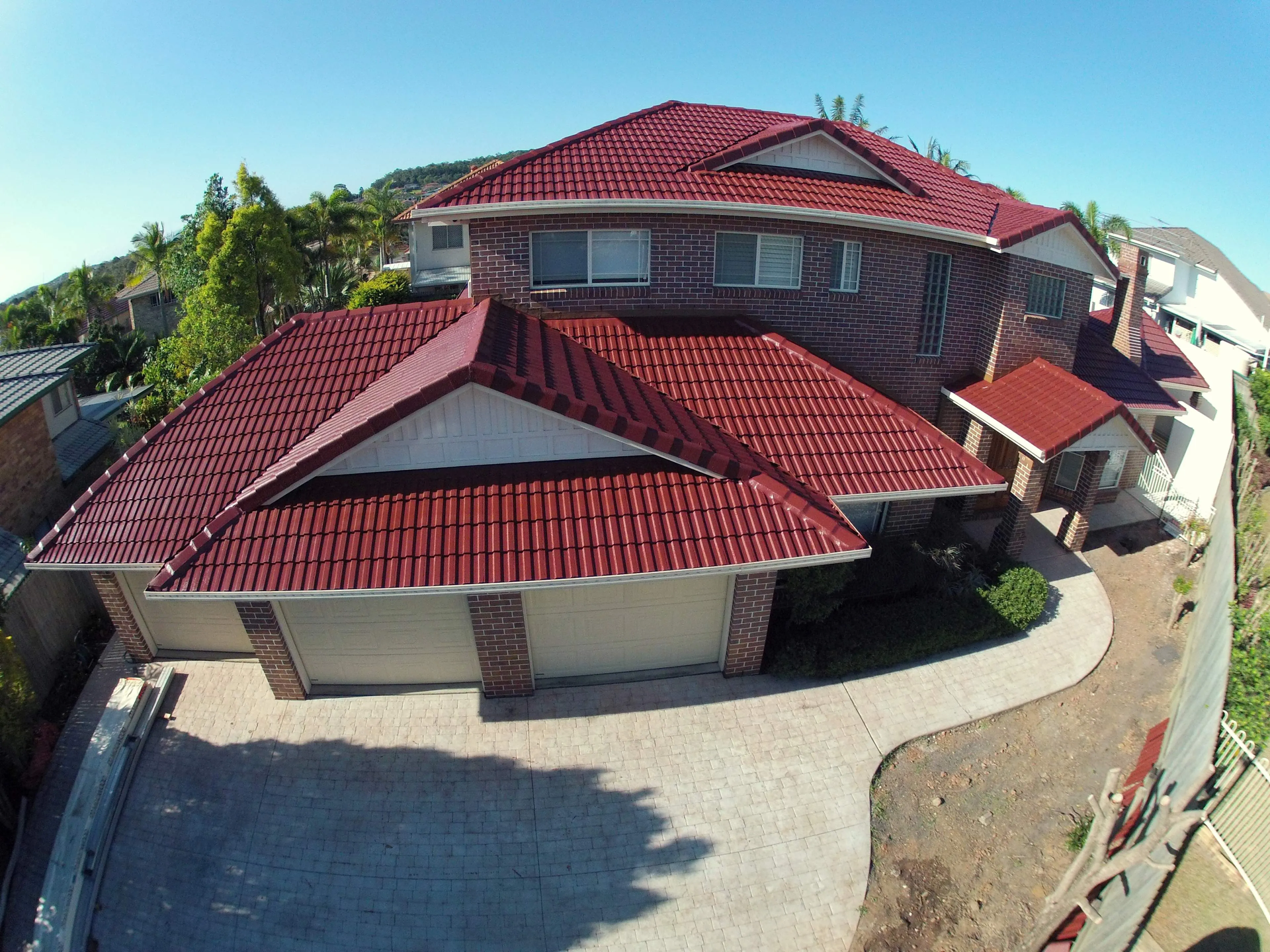 An aerial view of a house with a red tiled roof