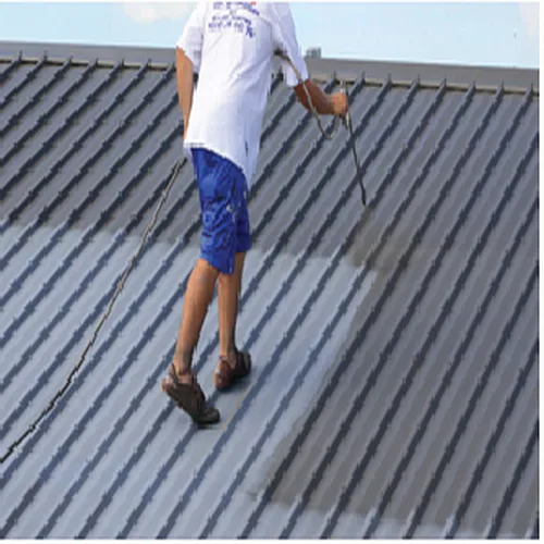 A man is painting a metal roof with a sprayer.