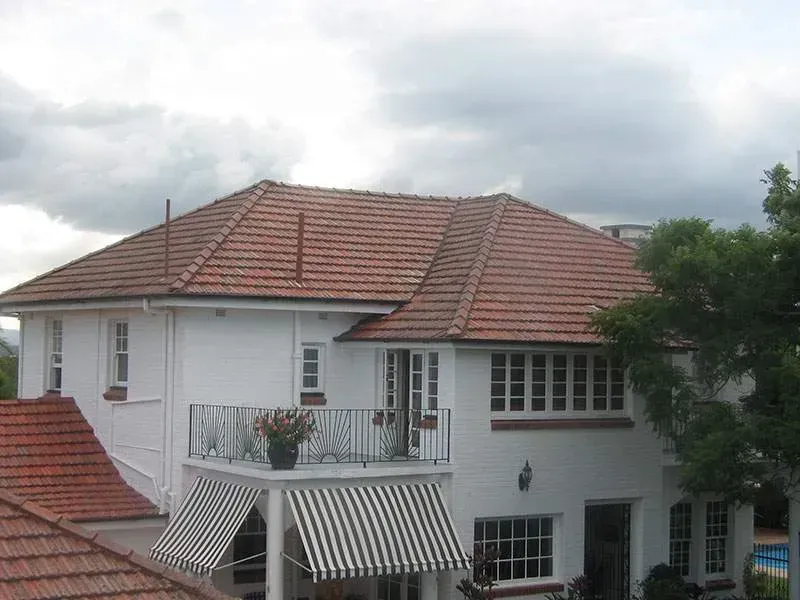 A large white house with a red tile roof
