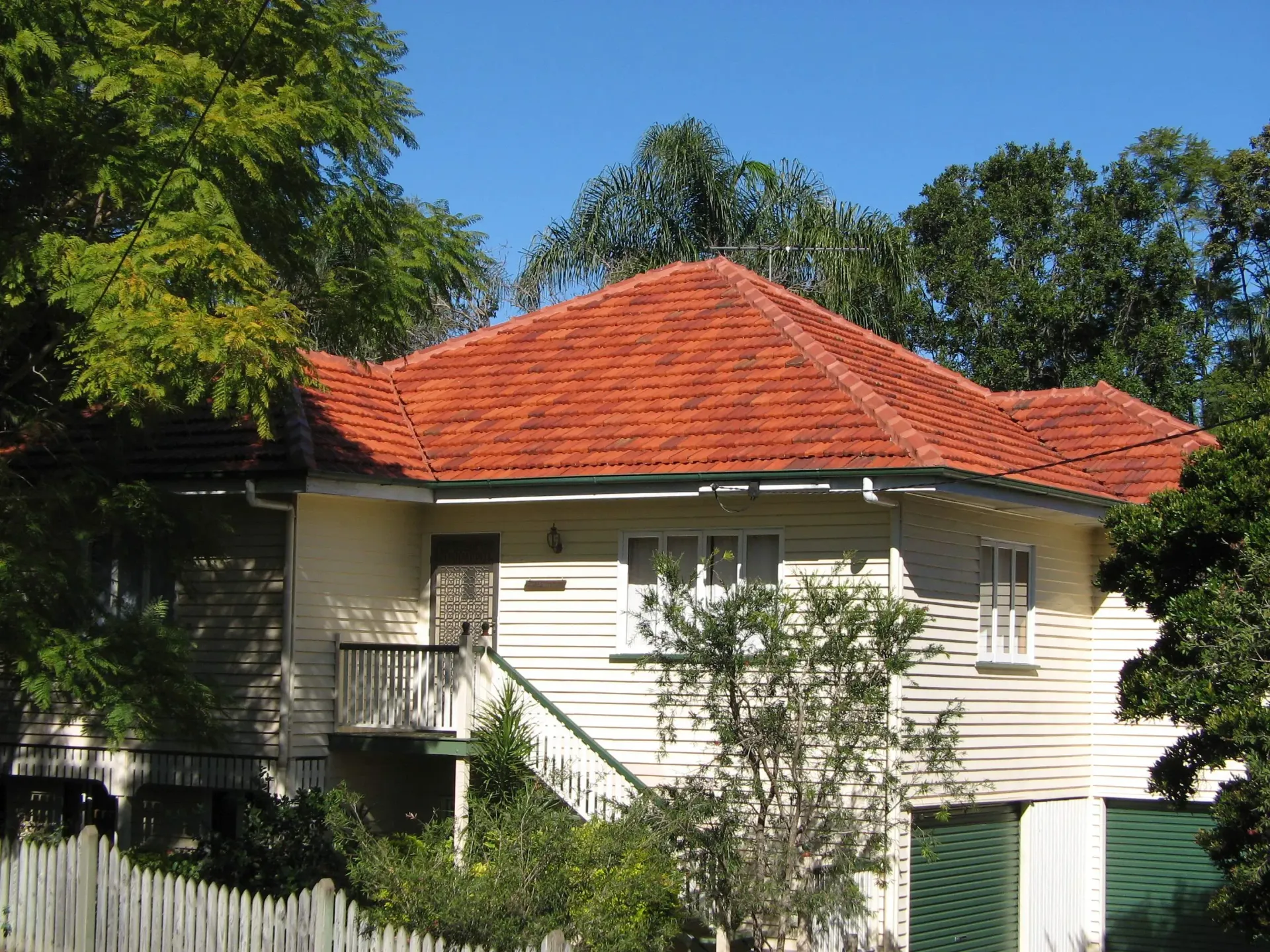 A white house with a red tiled roof
