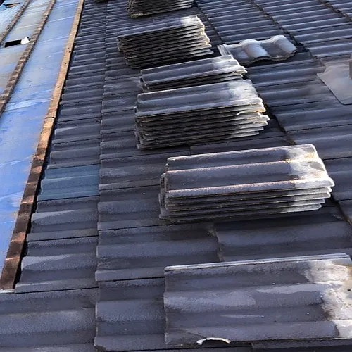 A row of tiles are stacked on top of each other on a roof.