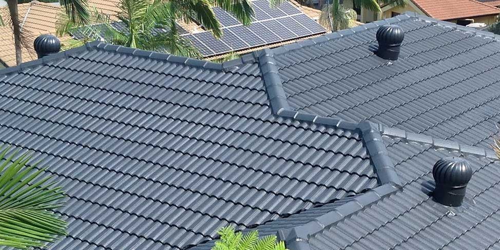 A roof with a lot of tiles and solar panels on it