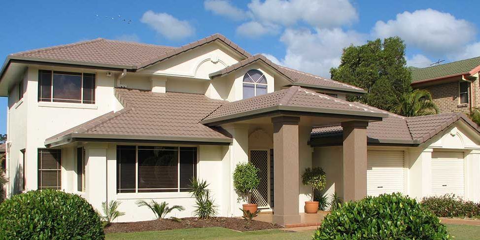 A large white house with a brown tile roof