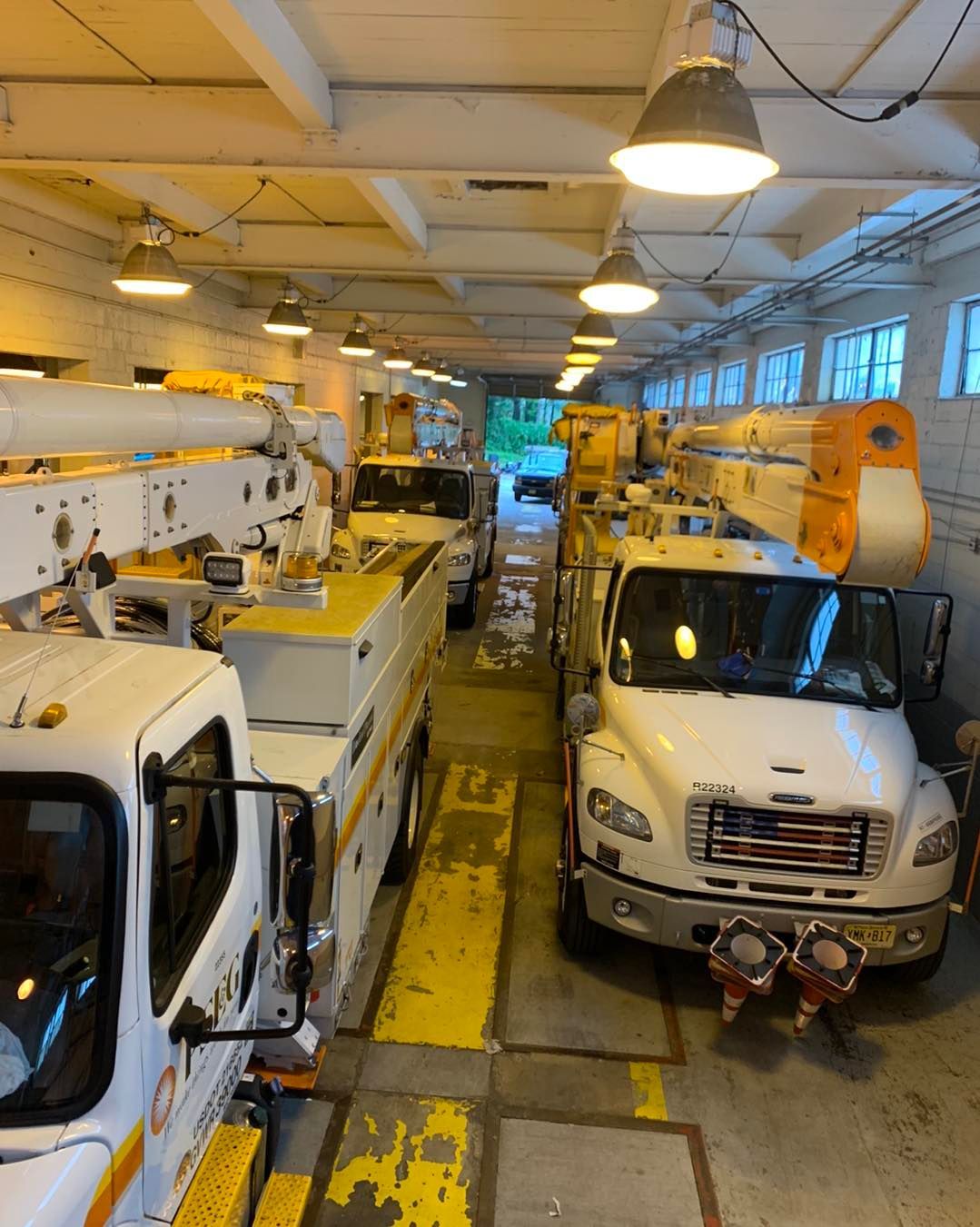 Blue Sperry Electric van parked outdoors with ladder on top.