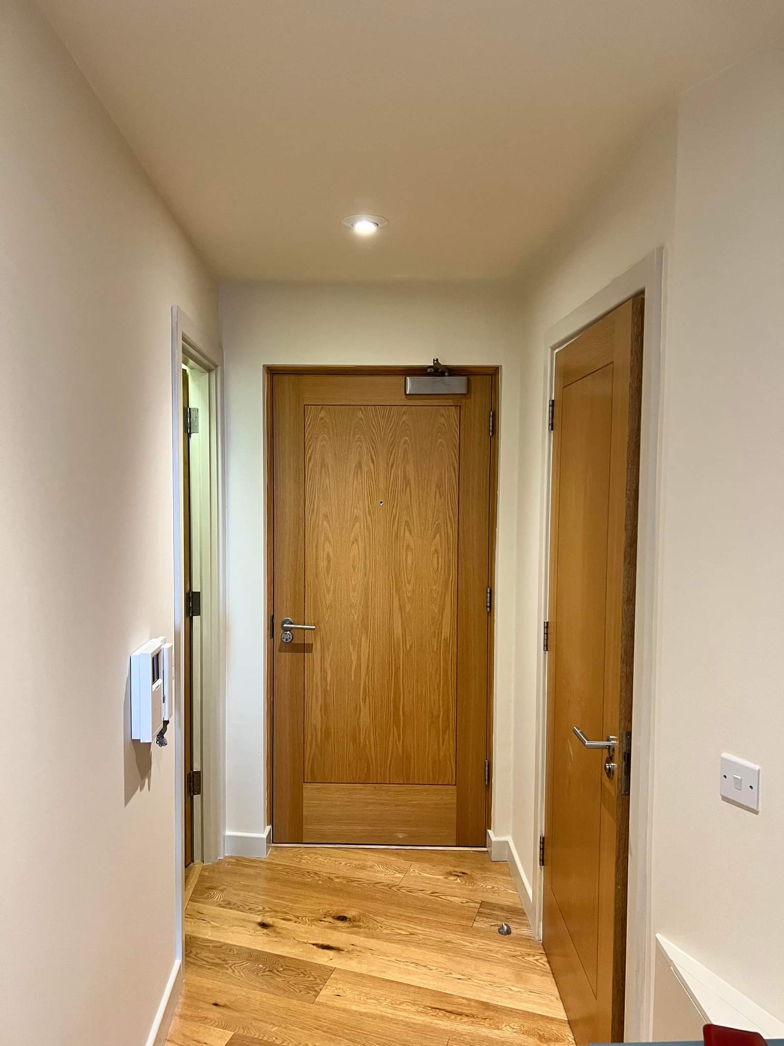 Picture of an apartment hallway painted in white by painters and decorators Leeds