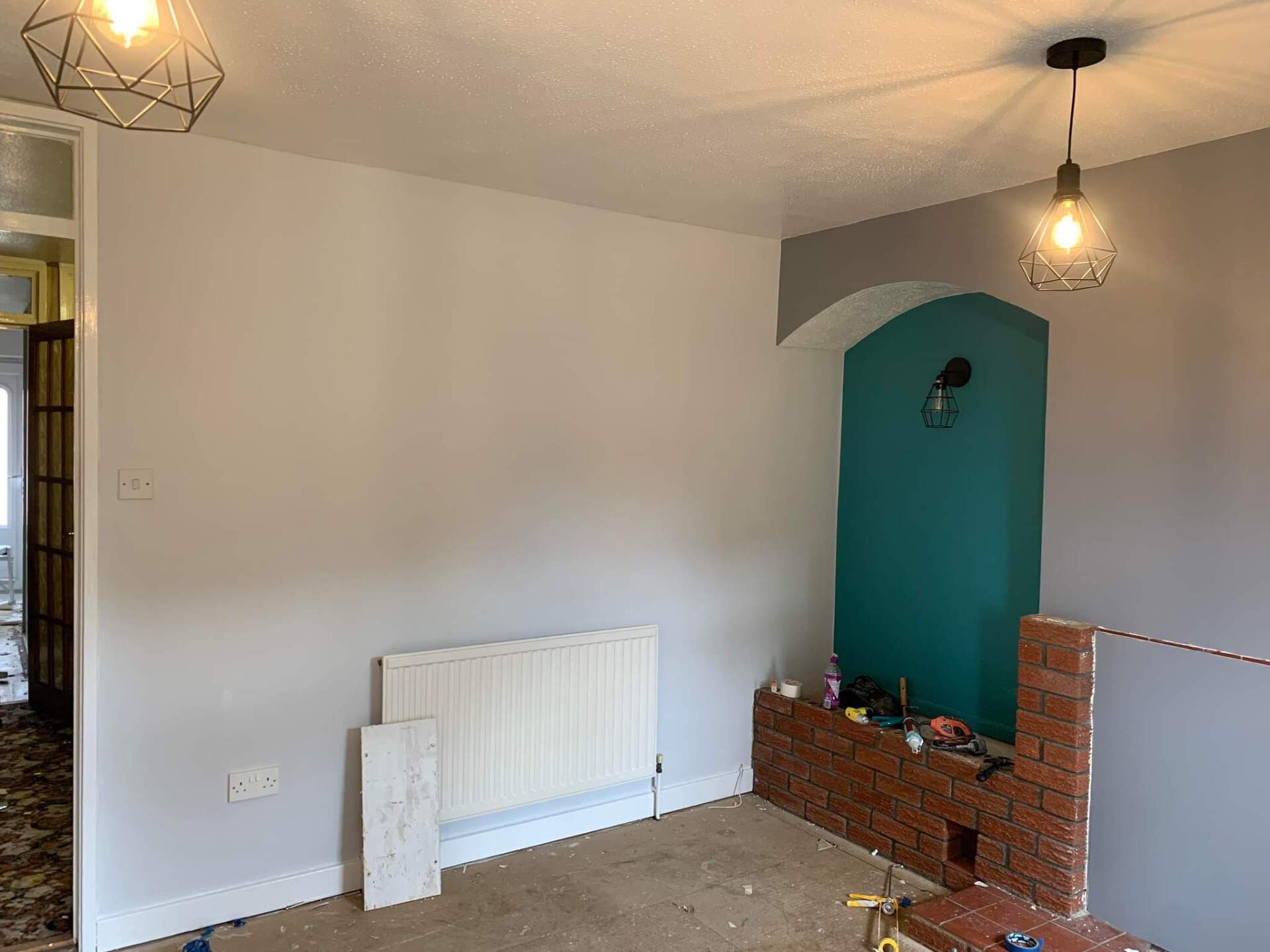 Picture of a living room feature wall painted blue and white by painters and decorators Leeds