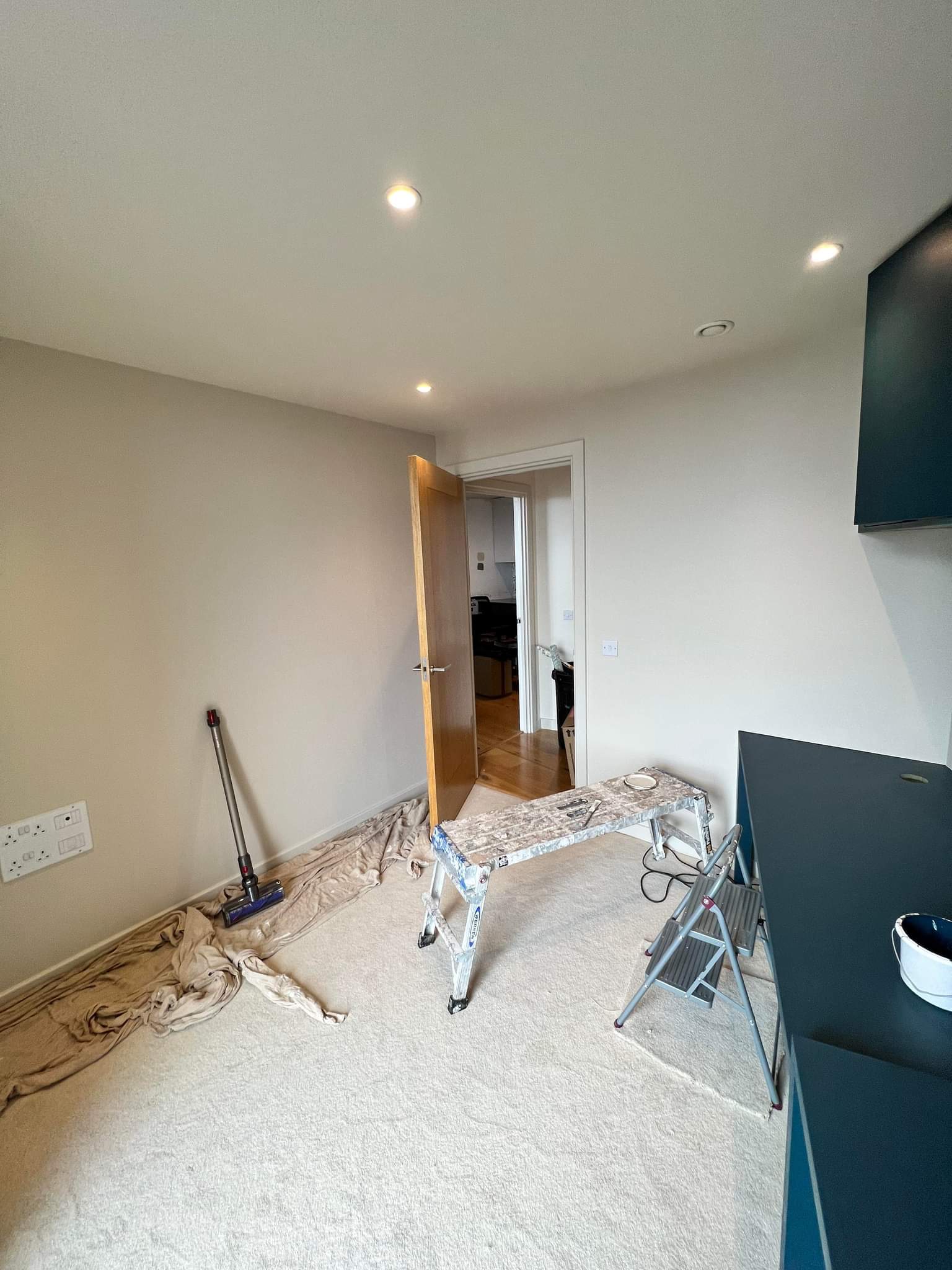 Picture of kitchen with whit walls and blue units painted by painters and decorators Leeds