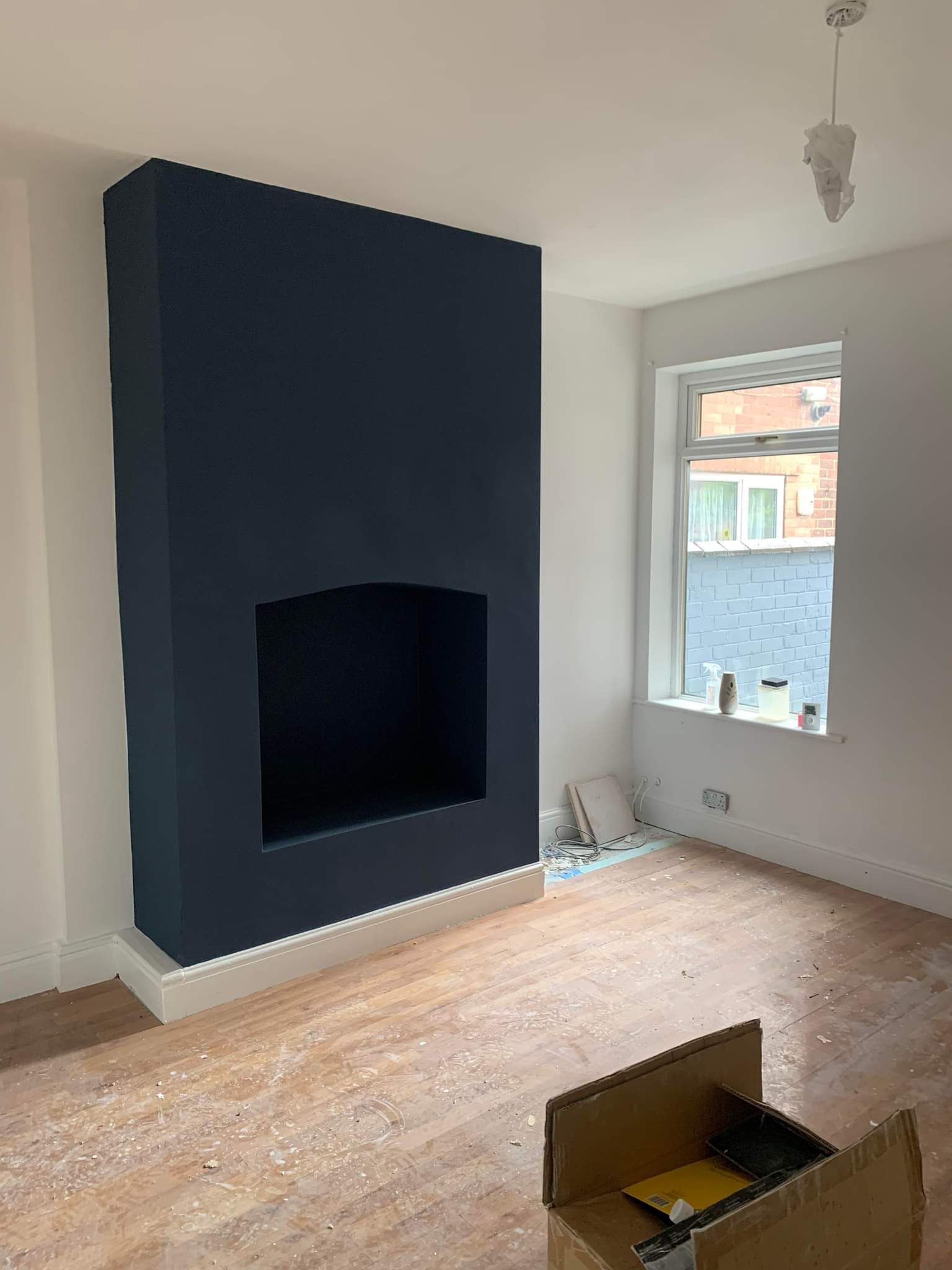 Picture of a living room feature wall newly decorated in blue by painters and decorators Leeds