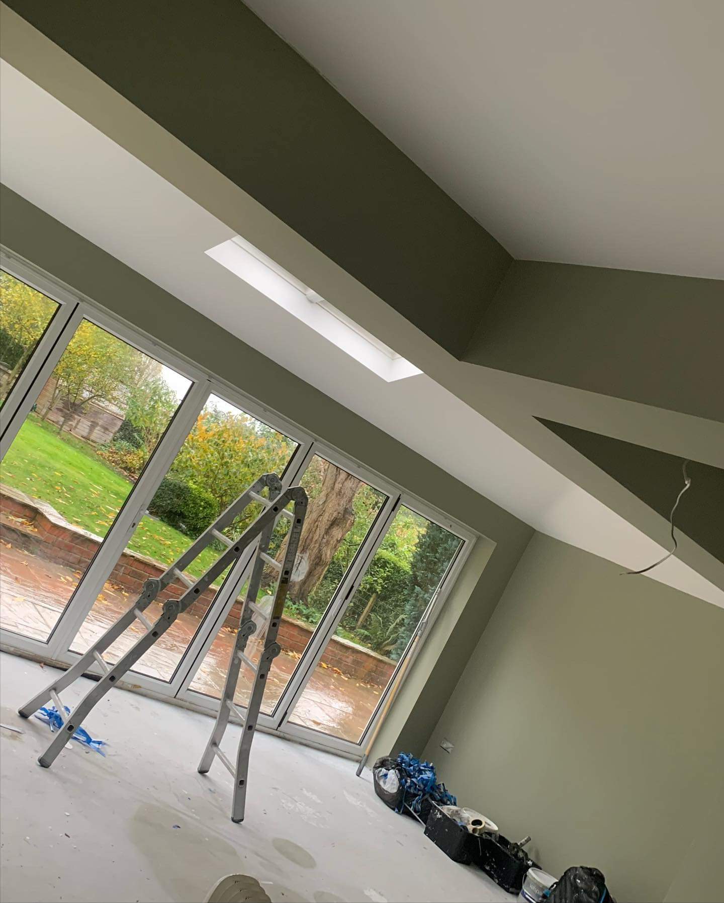 Picture of an sage green kitchen diner painted by  painters and decorators Leeds