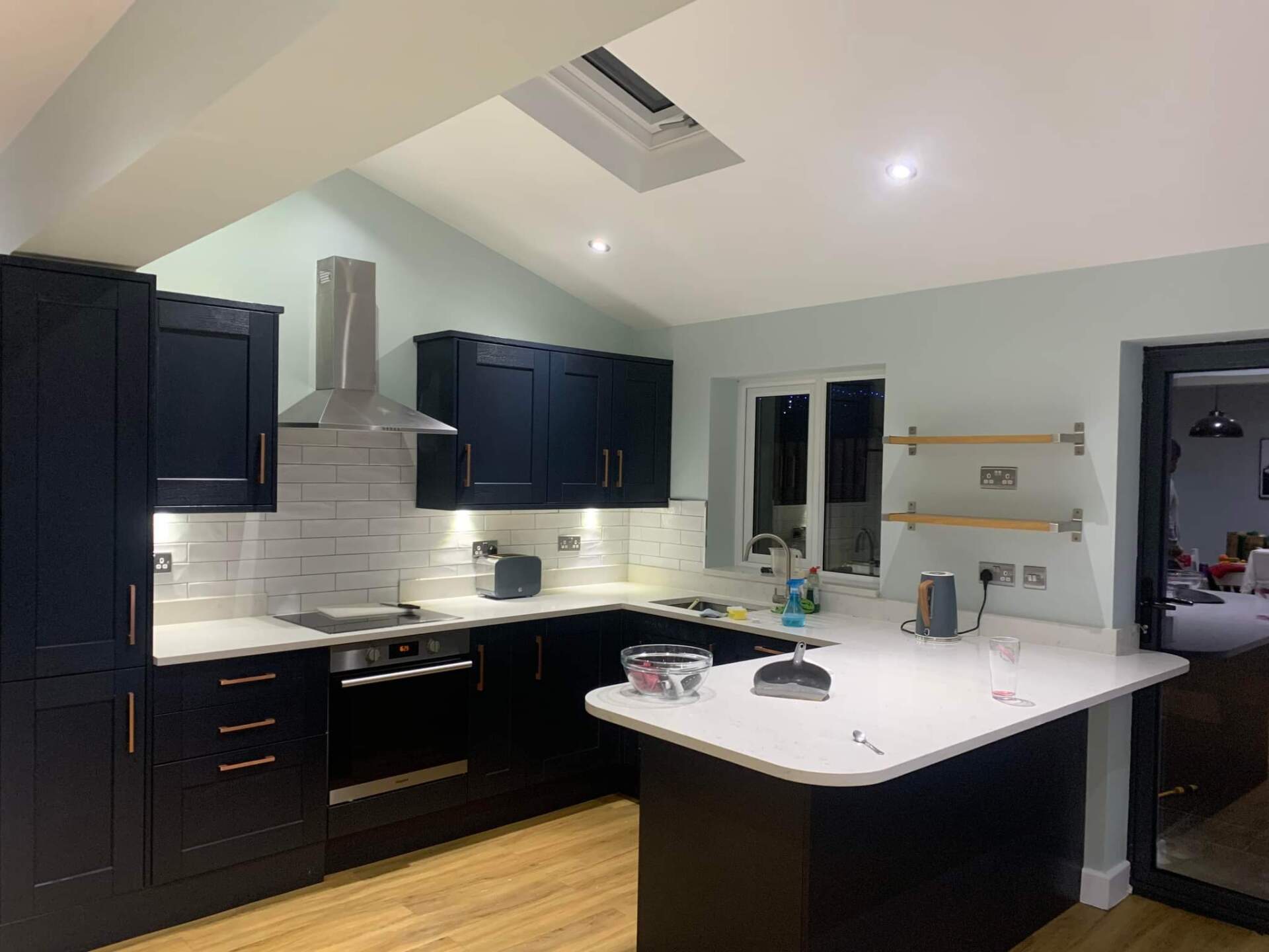 Picture of a kitchen with nay units and white walls finished by painters and decorators Leeds