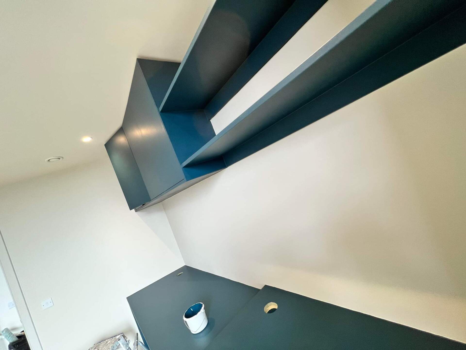 Picture of an kitchen with white walls and navy blue worktops and units redecorated by painters and decorators Leeds