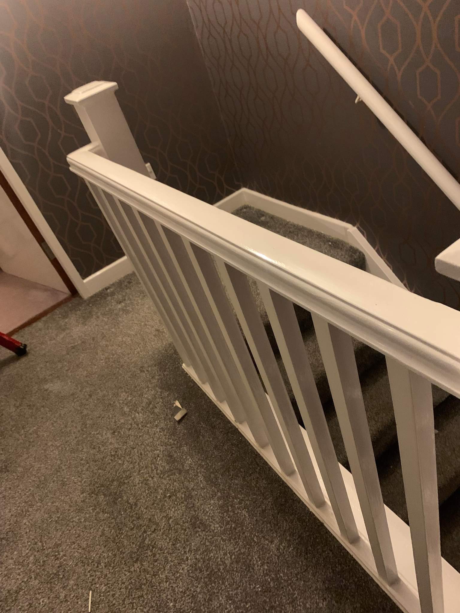 Picture of a stairs and landing newly wallpapered by painters and decorators Leeds