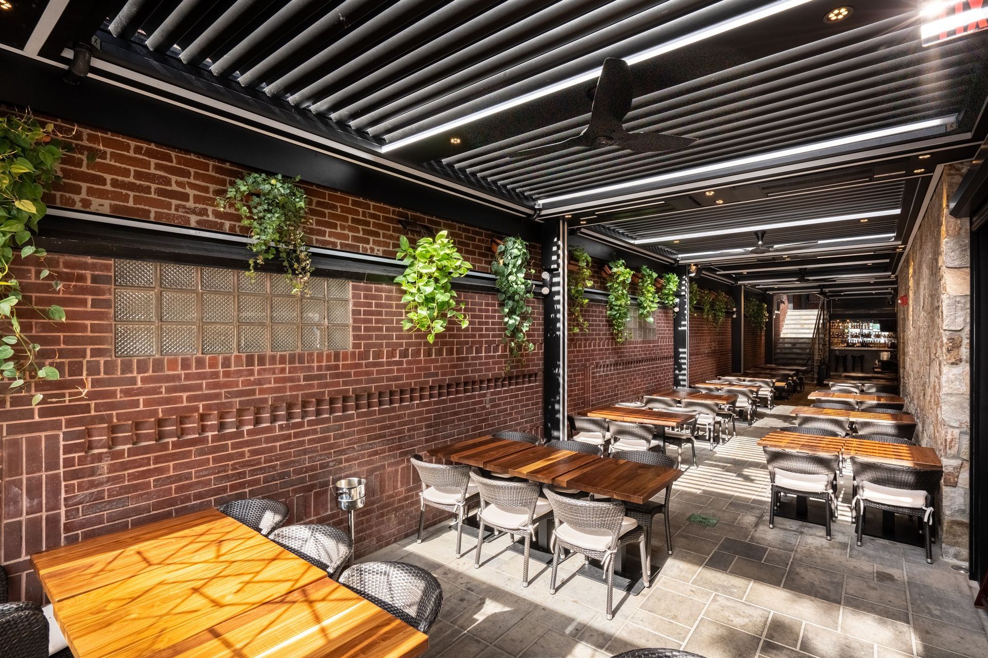 Luxury backyard pergola with integrated lighting and comfortable outdoor seating