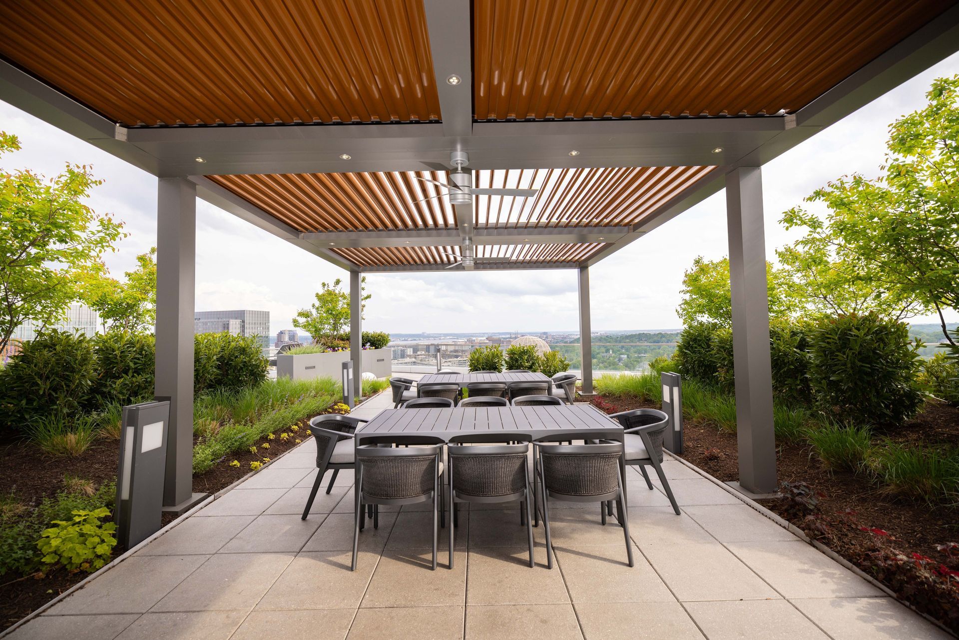 Modern pergola covering an outdoor dining area with built-in shade and seating