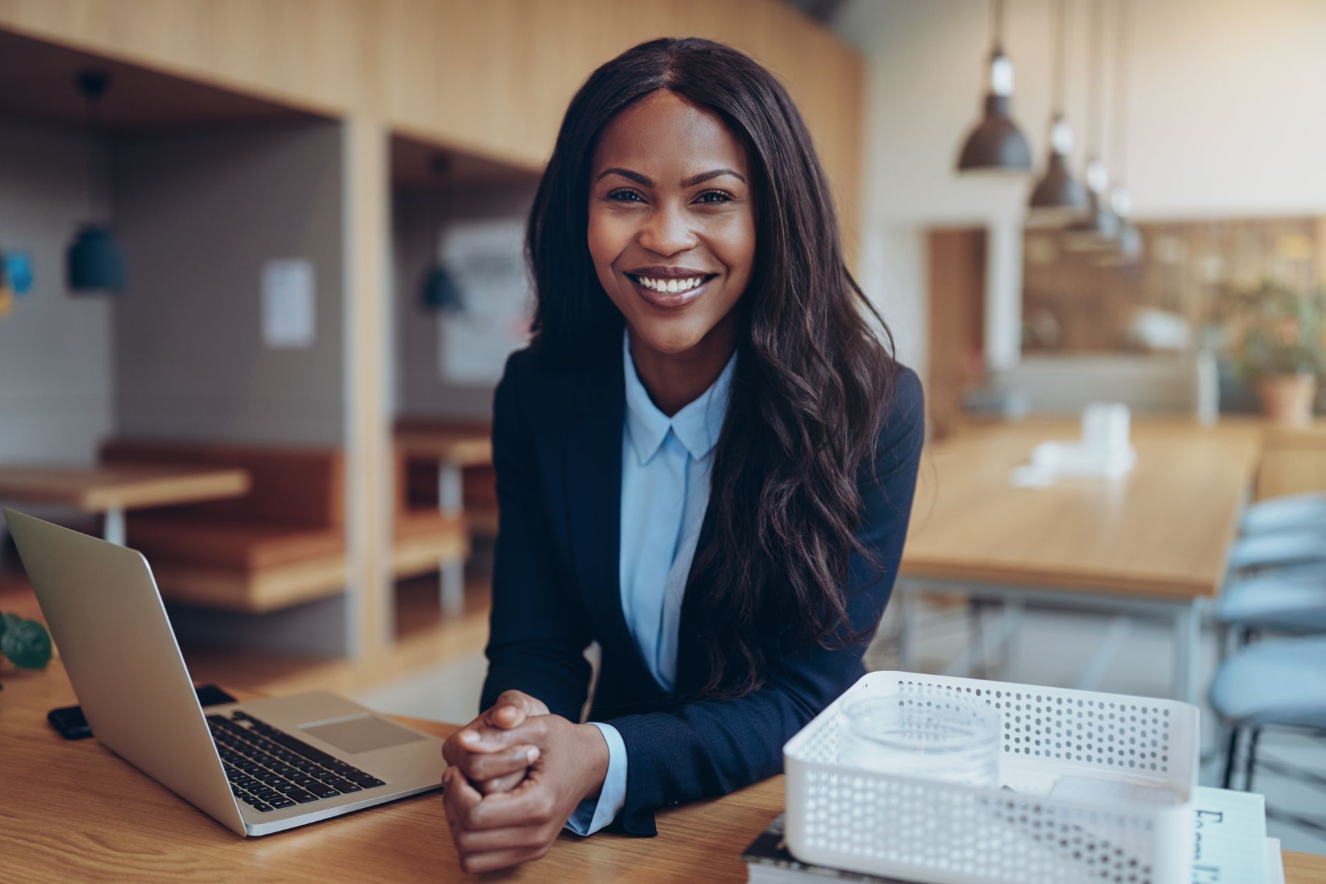 Business professional smiling while working on a laptop