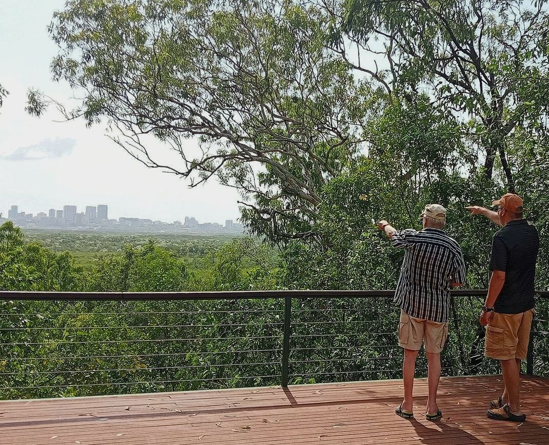 Two Men Are Standing on a Balcony Overlooking a Forest  — NT Driver Guide - Escorted Touring & Transfers in Darwin City, NT