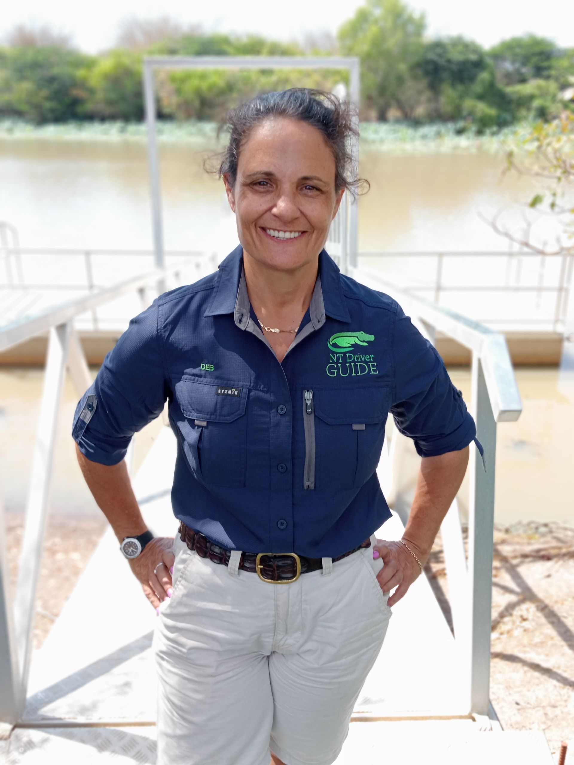 A Woman is Standing in Front of a Body of Water  — NT Driver Guide - Escorted Touring & Transfers in Darwin City, NT