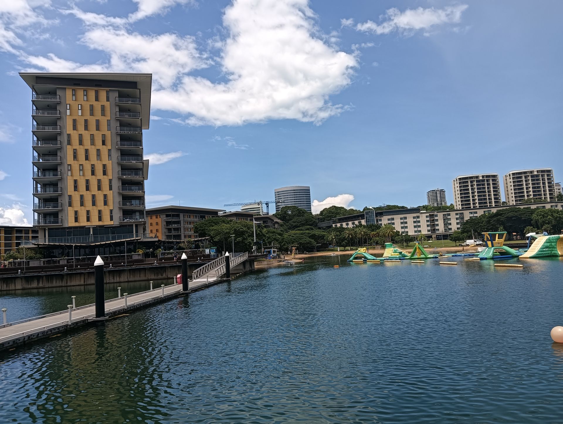 Coastal view with a pier extending into blue water — NT Driver Guide - Escorted Tours & Transfers in Darwin City, NT