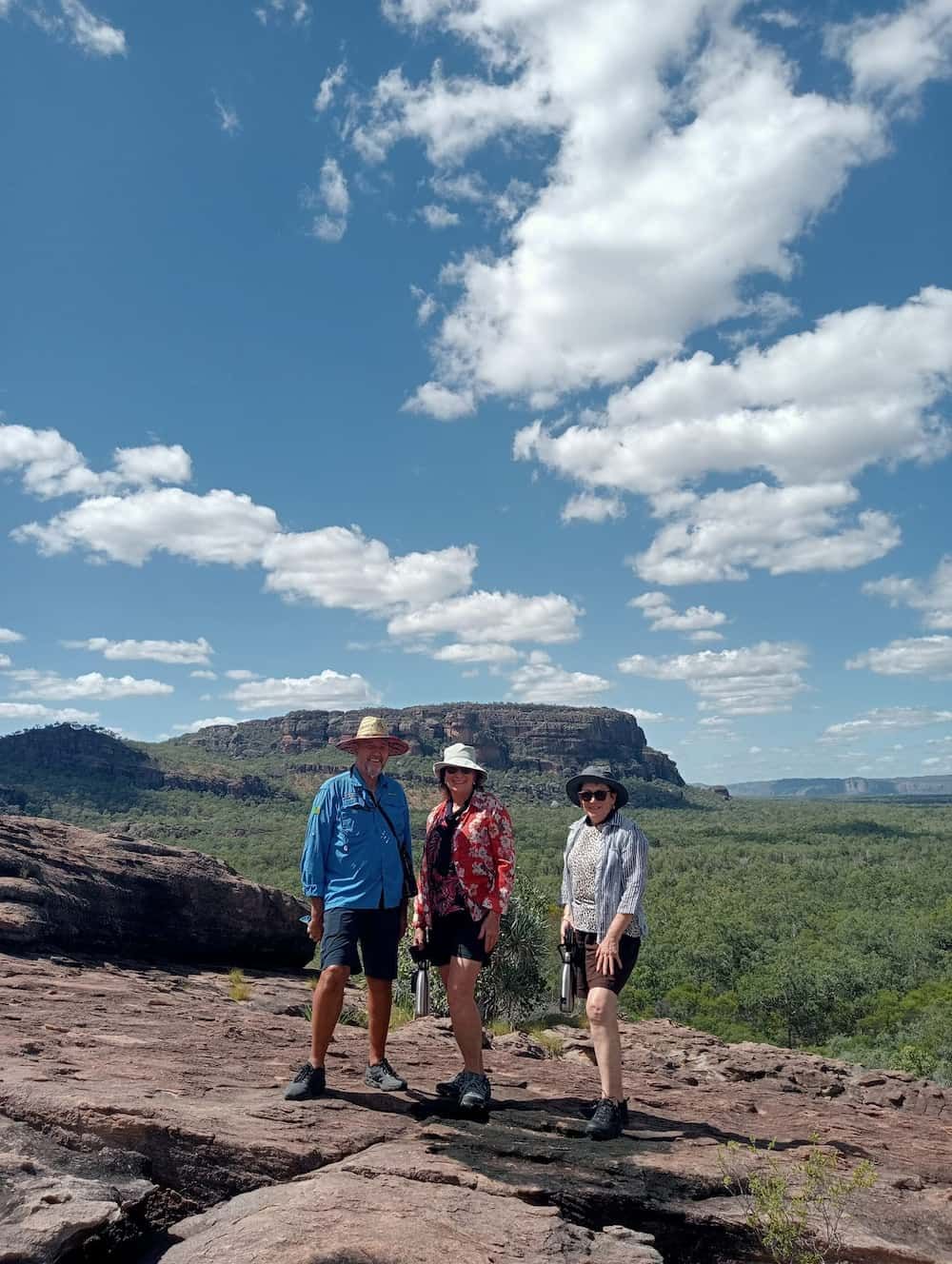 Three People Are Standing on Top of a Rocky Hill  — NT Driver Guide - Escorted Touring & Transfers in Darwin City, NT