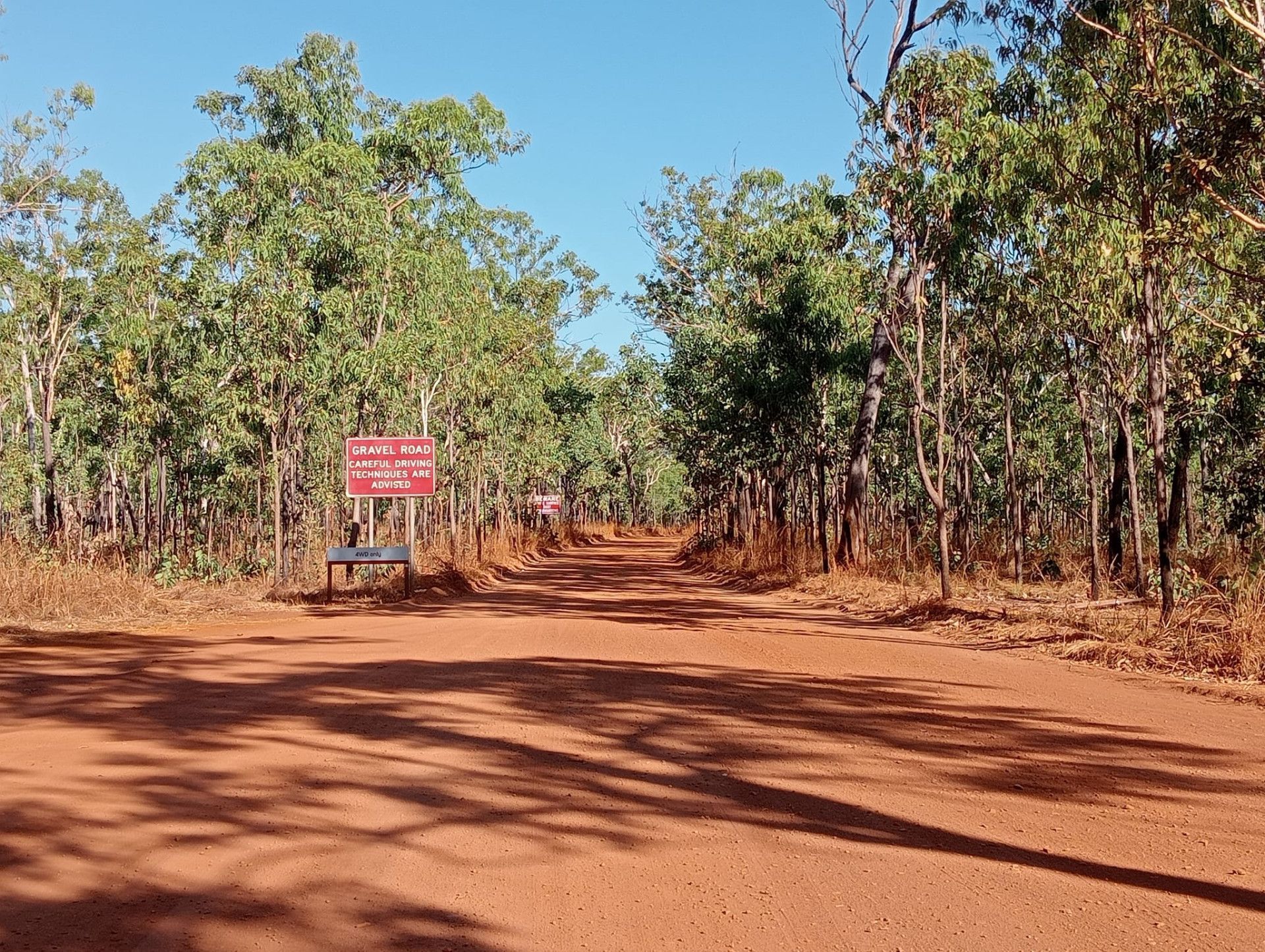 Dirt Car Track with A Be Careful Sign — NT Driver Guide - Escorted Touring & Transfers in Darwin City, NT