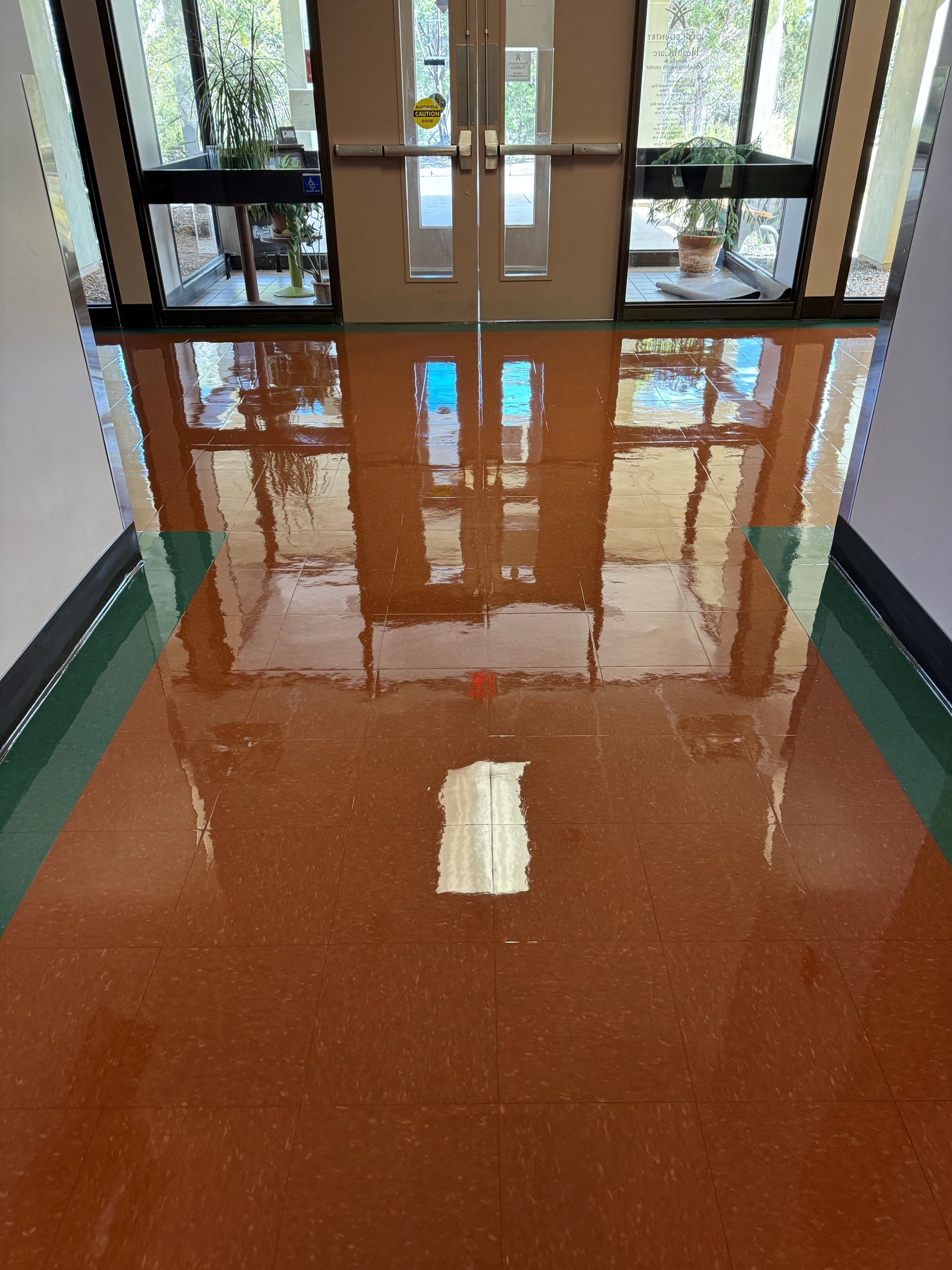 A hallway in a building with a shiny floor