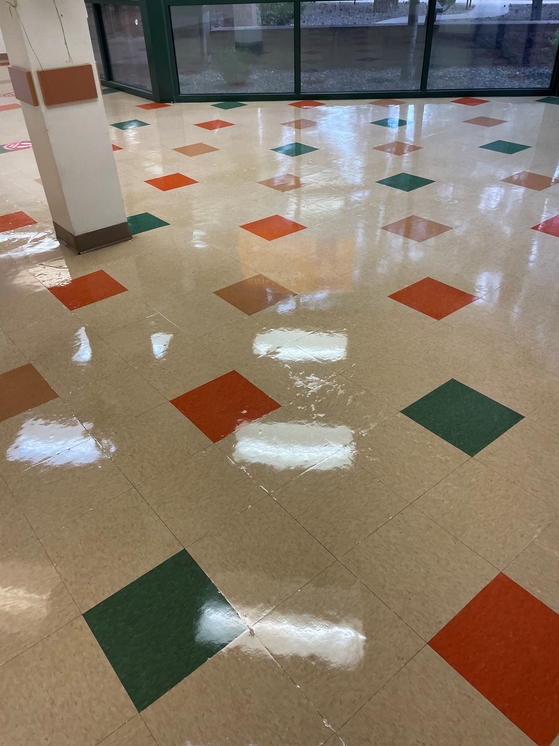 A colorful tiled floor in a room with a window.