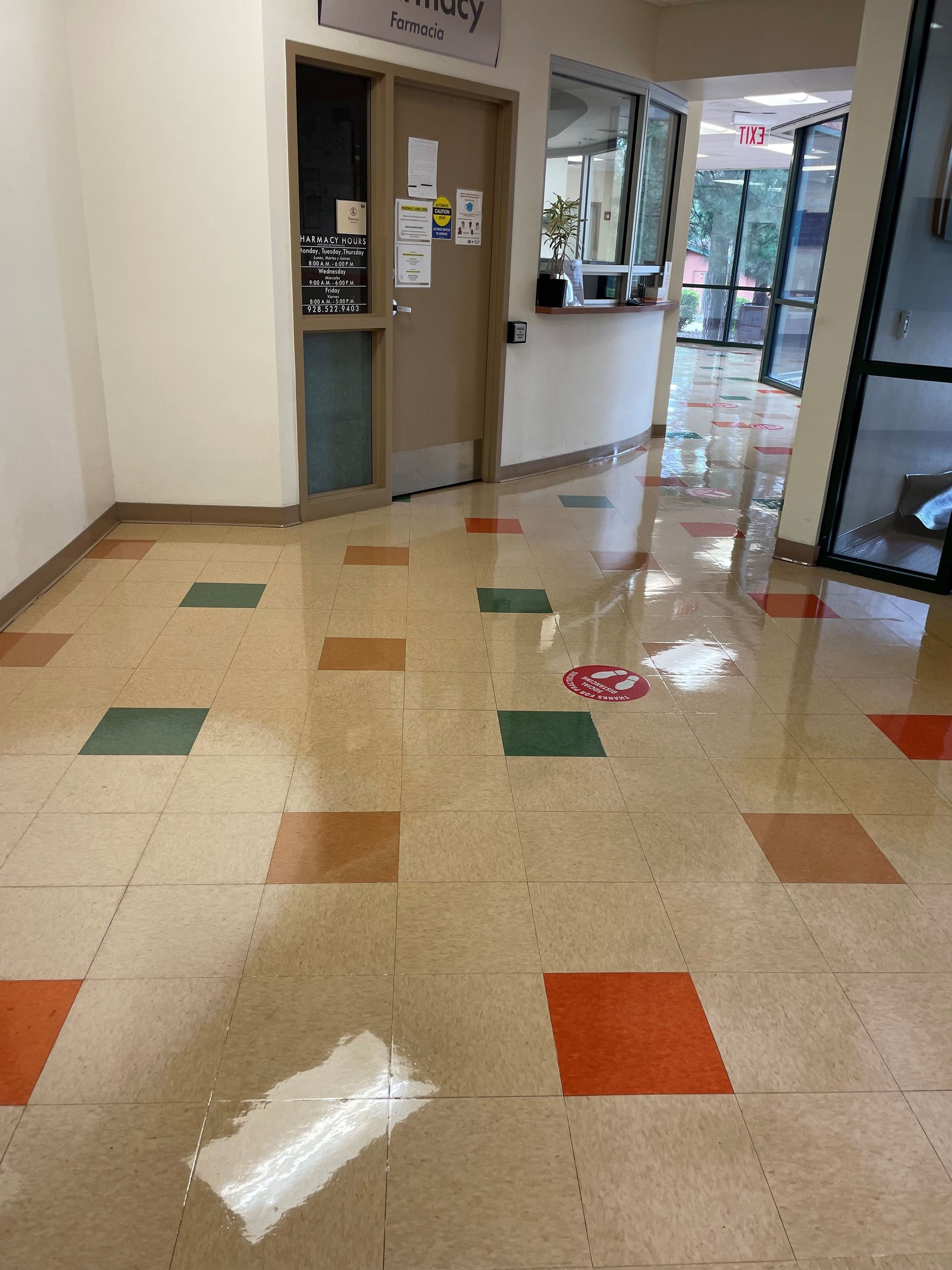 A hallway with a tiled floor and a door