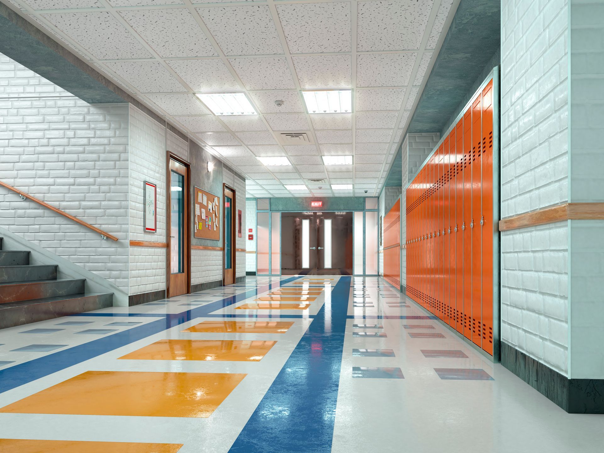 An empty school hallway with lockers and stairs.