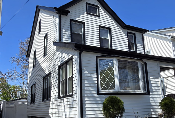 Elite Homes of NY installing CertainTeed Monogram vinyl siding on a Queens home