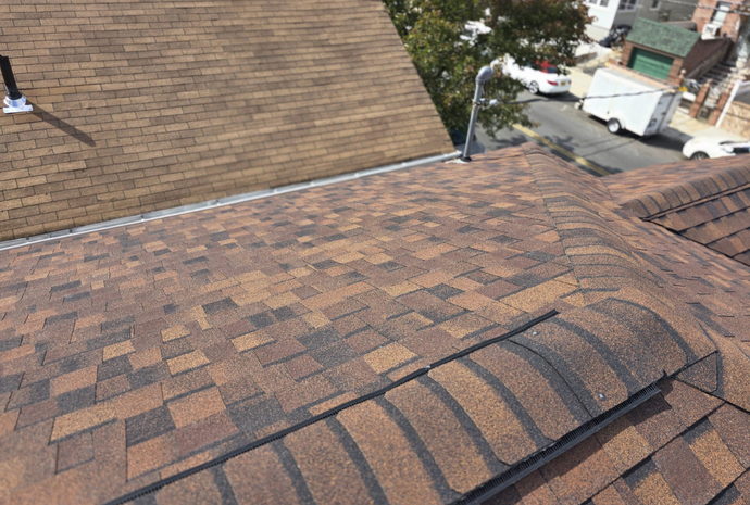 Elite Homes of NY crew installing CertainTeed shingles on a Bronx home