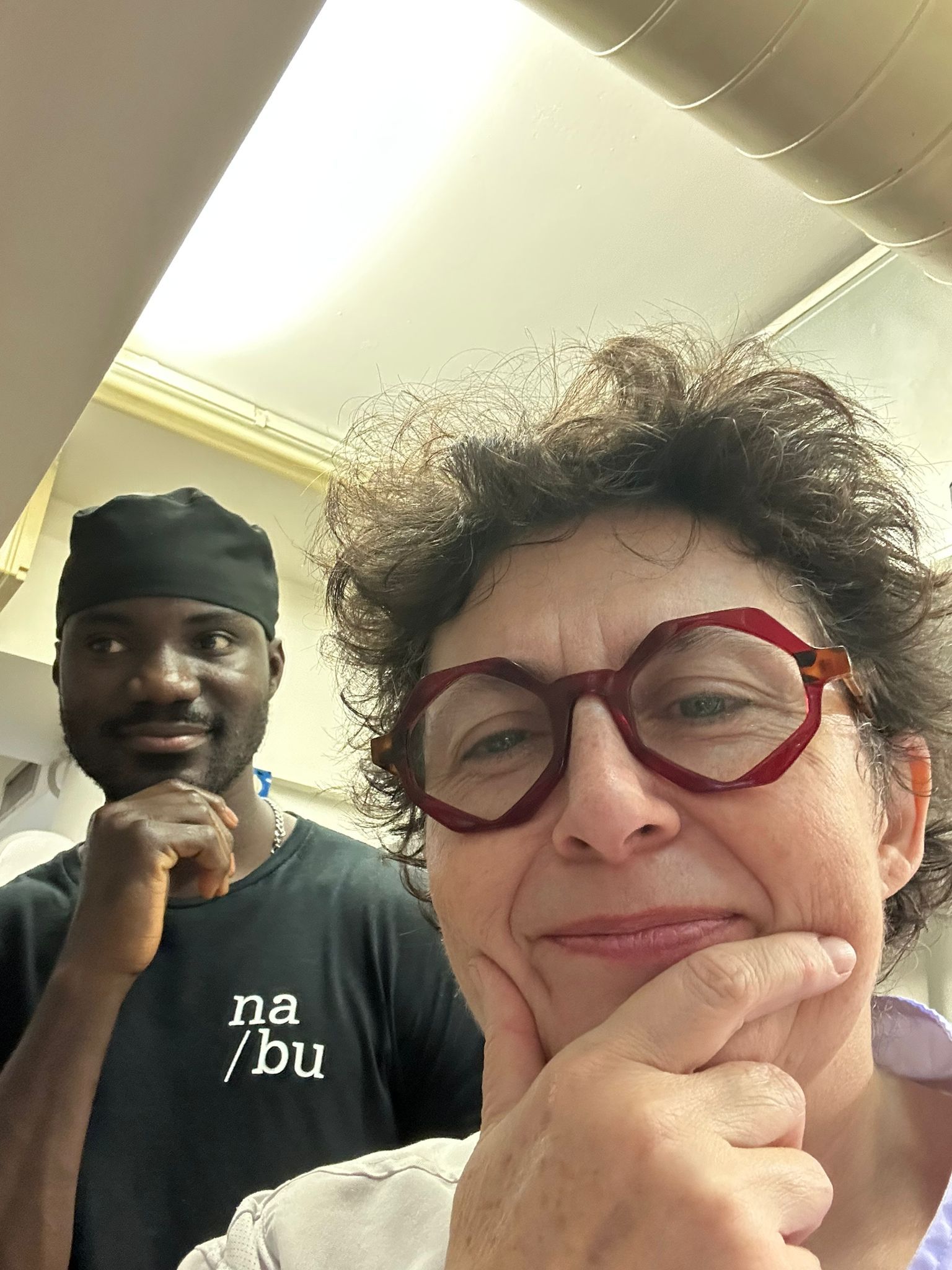 Due polpette in salsa di pomodoro, guarnite con menta e un crostino su un piatto bianco in cucina.