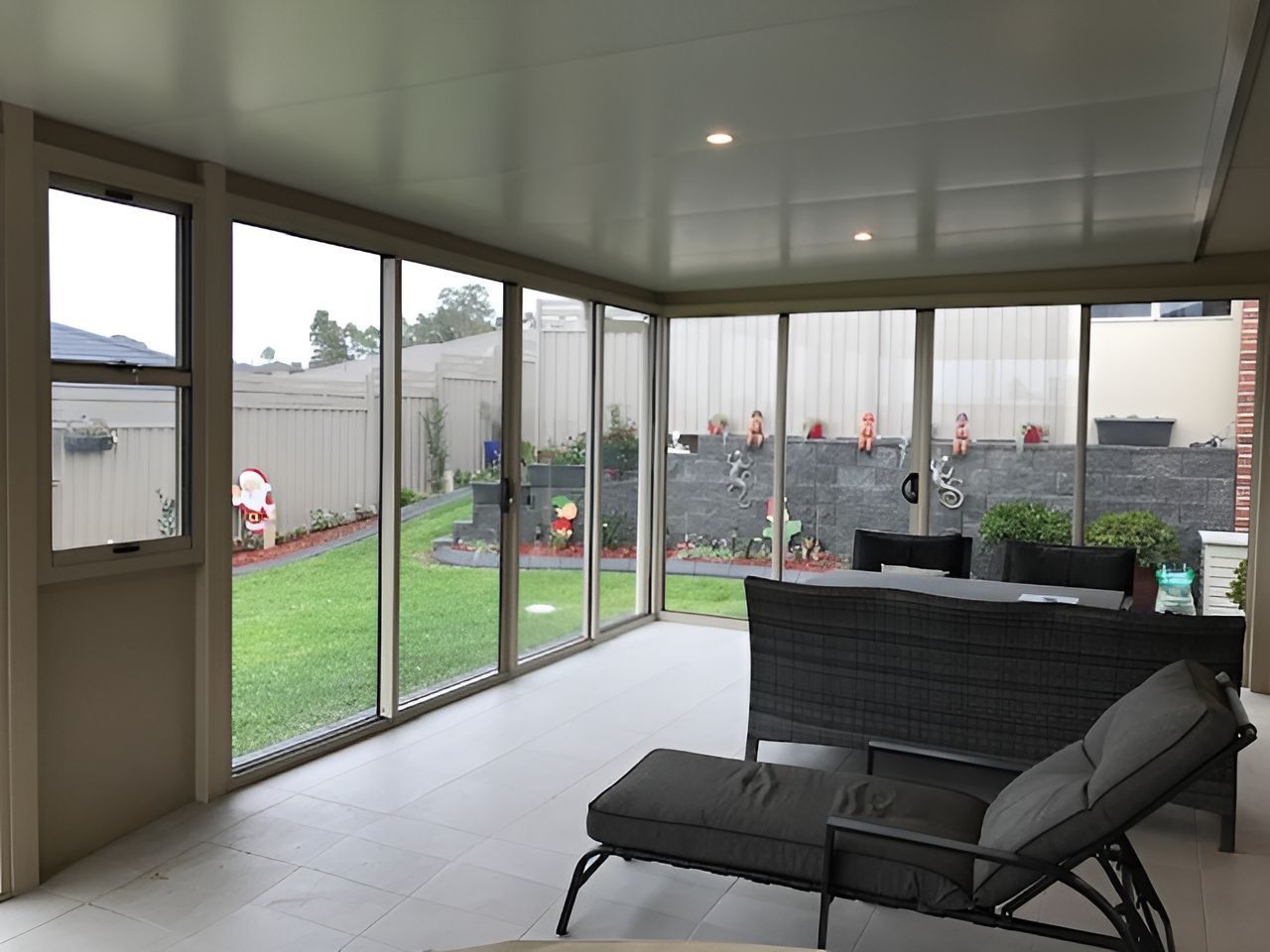 A Living Room With A Lot Of Windows And A Couch — Master Glass & Glazing In Eleebana, NSW