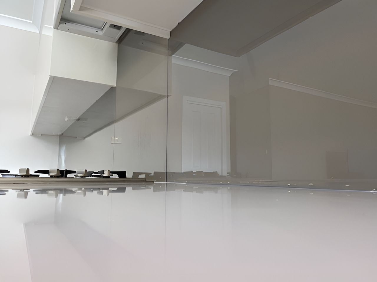 A Kitchen With A Stove Top Oven And A White Counter Top — Master Glass & Glazing In Eleebana, NSW