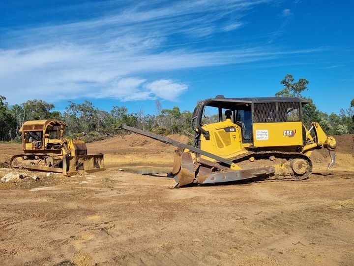 Bulldozer On Grass Field — Earthmoving in Toowoomba, QLD