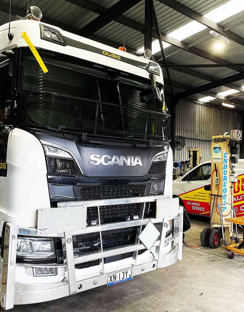 a Scania truck, with the Southern Auto Glass service vehicle on the background