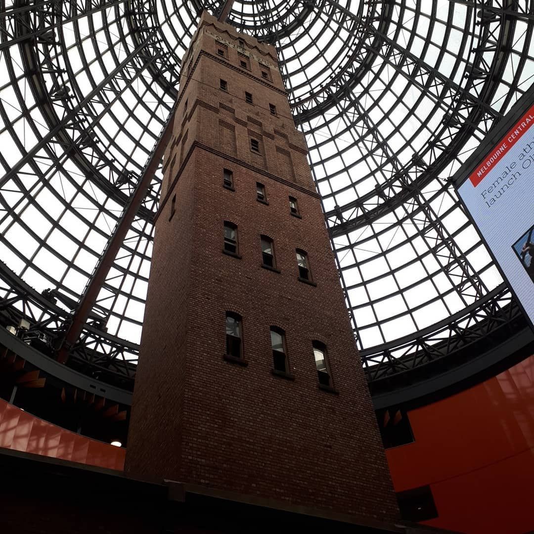 Looking Up At A Tall Brick Building With A Dome Roof — Pottsville Carpentry and Home Maintenance In Pottsville, NSW