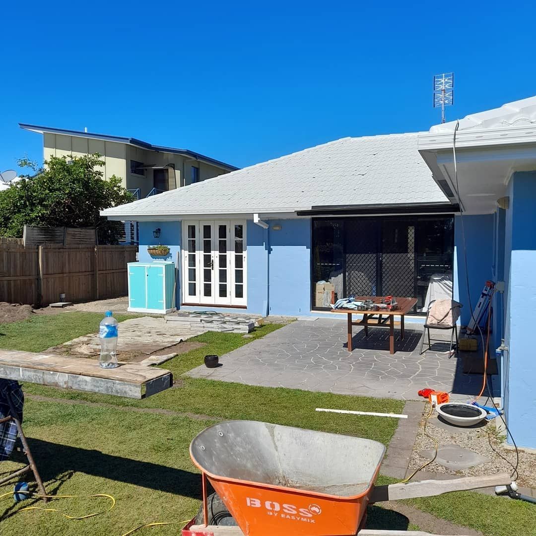 A Wheelbarrow Is Sitting In Front Of A House — Pottsville Carpentry and Home Maintenance In Pottsville, NSW
