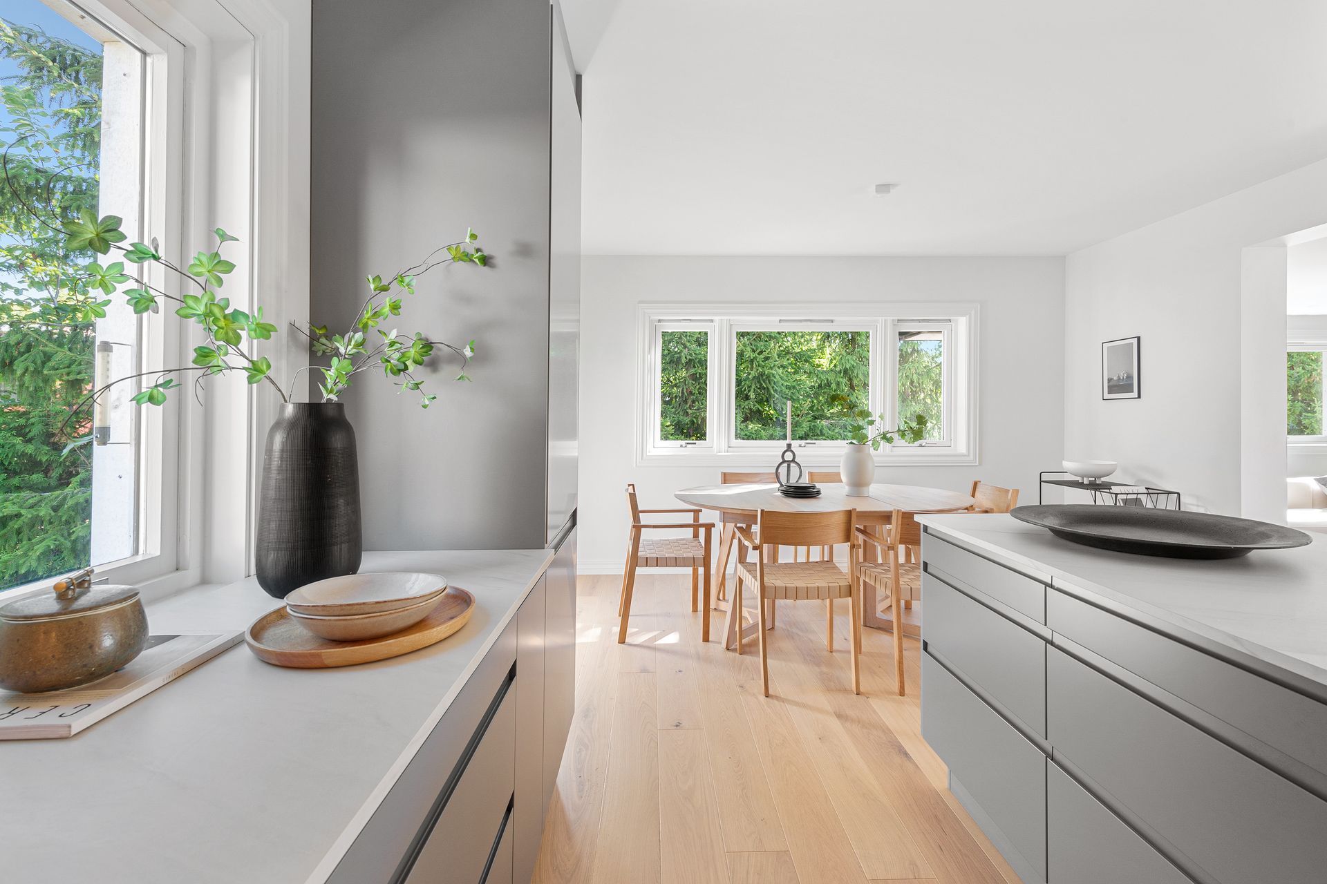 A kitchen with a table and chairs and a window.