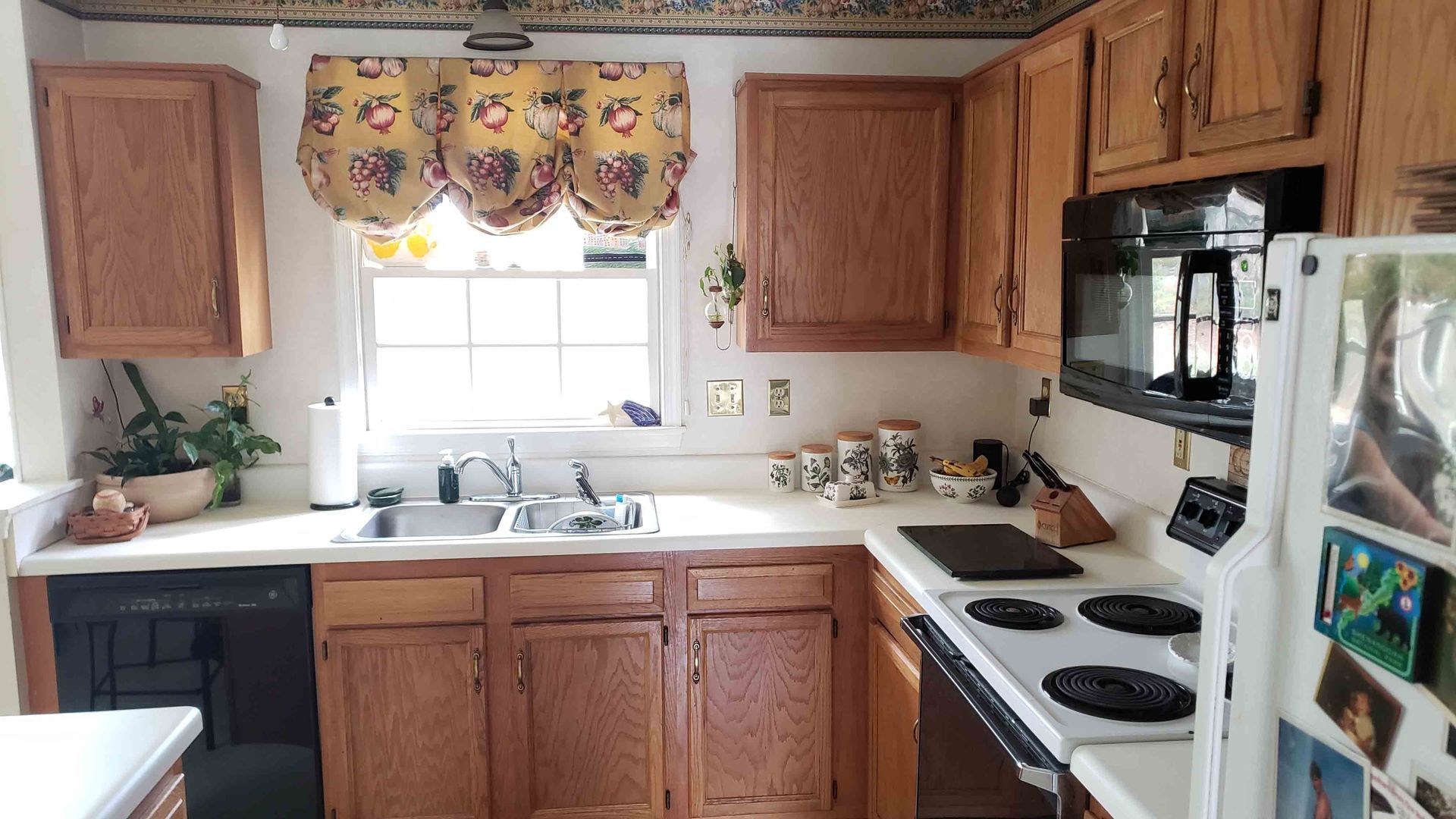 A kitchen with wooden cabinets and a white refrigerator