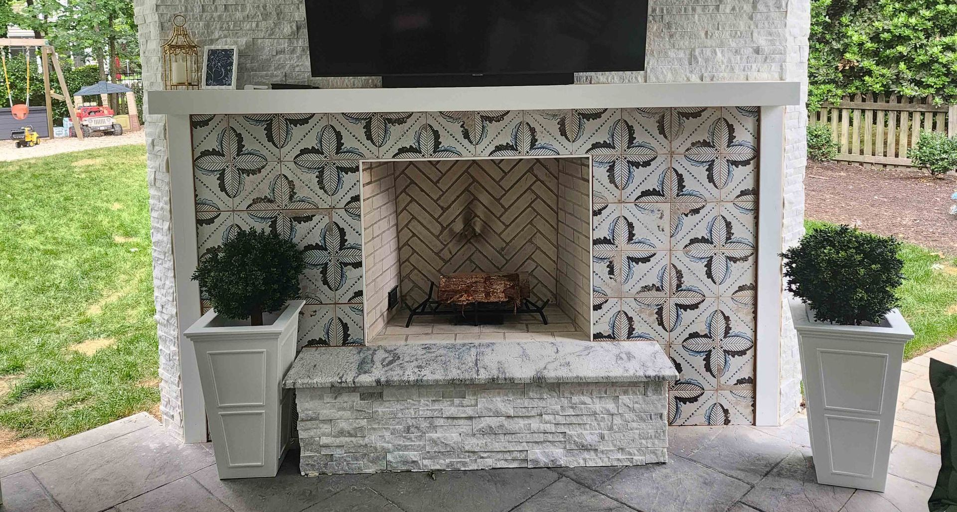 A fireplace with a flat screen tv mounted on top of it.