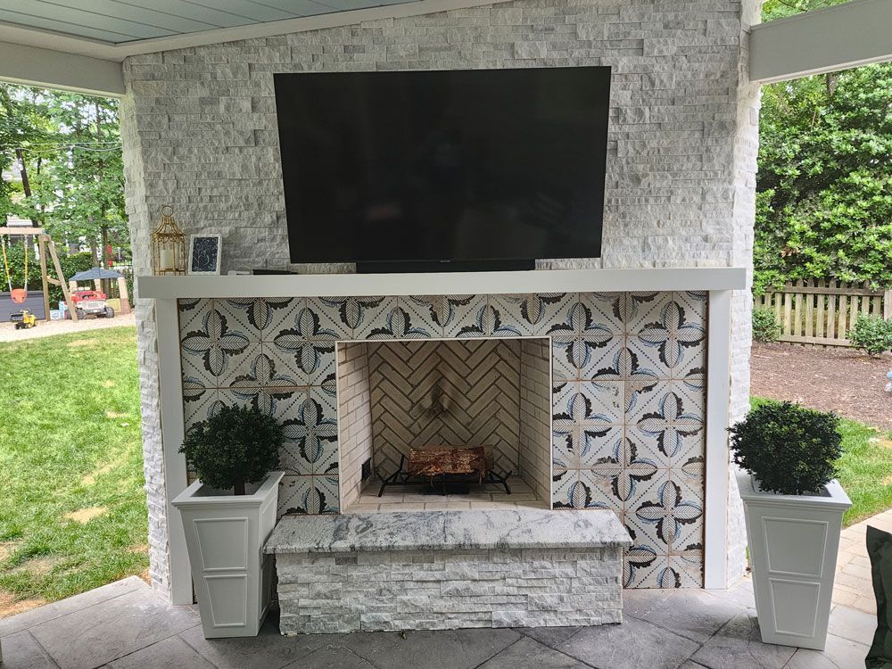 A fireplace with a flat screen tv mounted above it.
