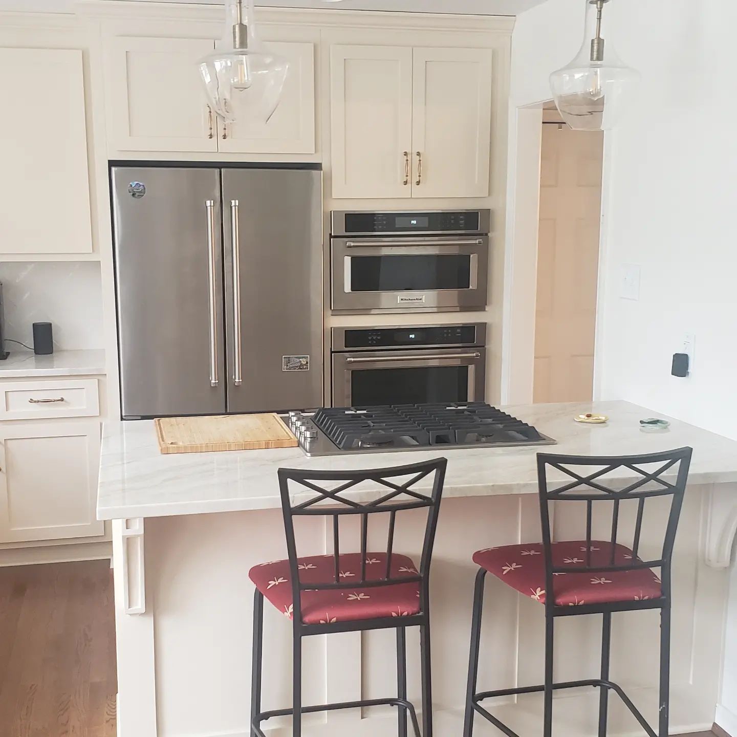 A kitchen with stainless steel appliances and white cabinets