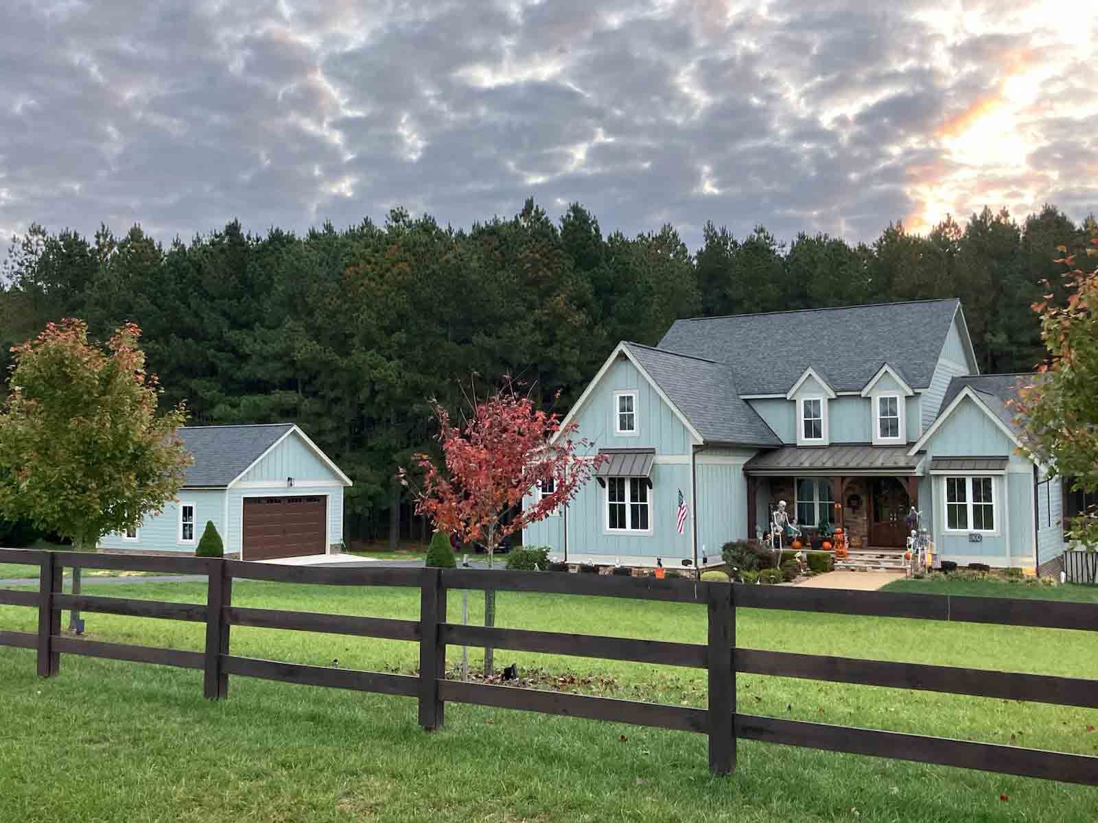 A house with a wooden fence in front of it