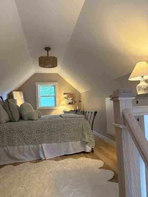 A bedroom with a bed and a window in the attic.