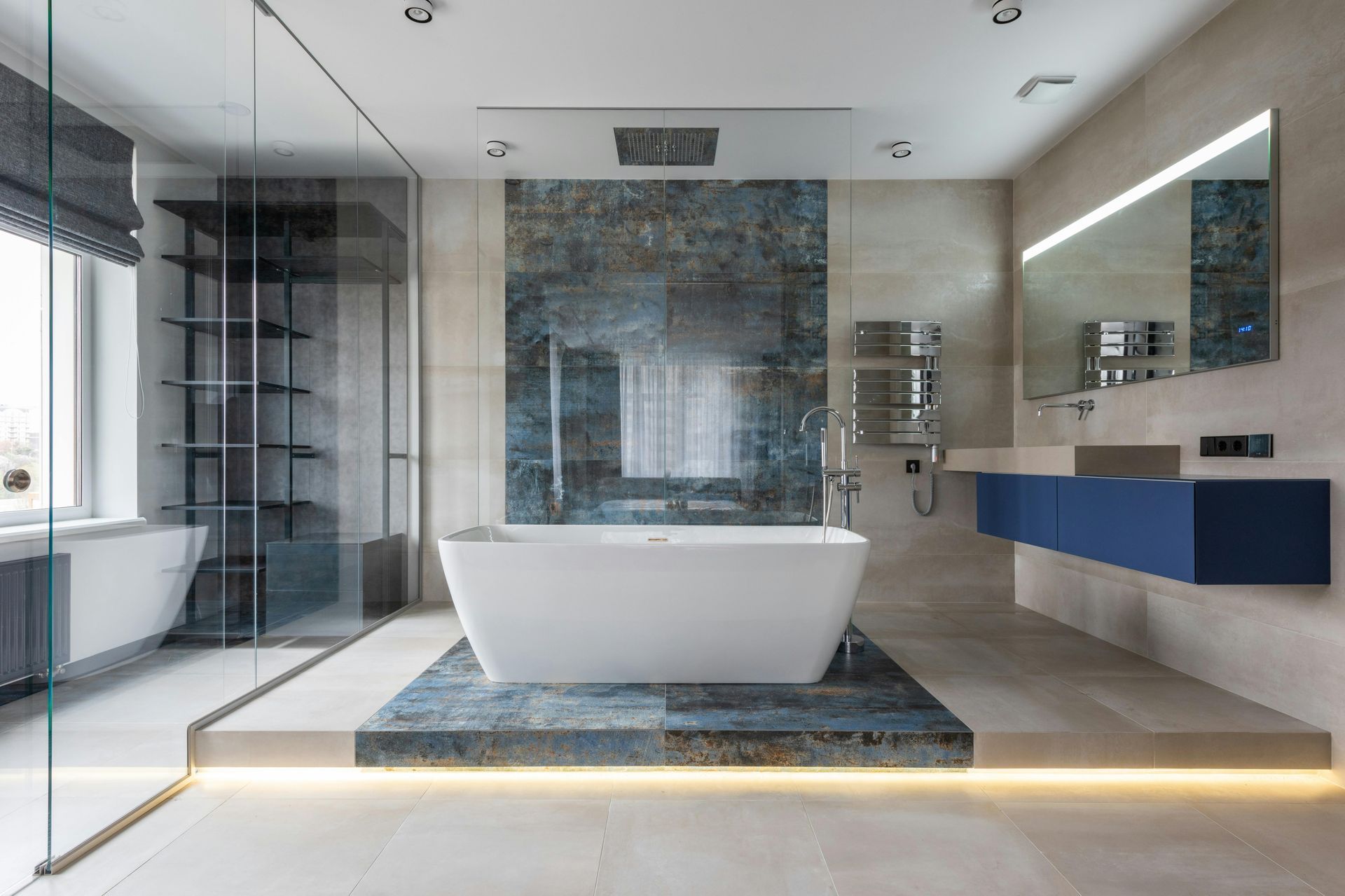 A bathroom with a bathtub , sink , mirror and walk in shower.