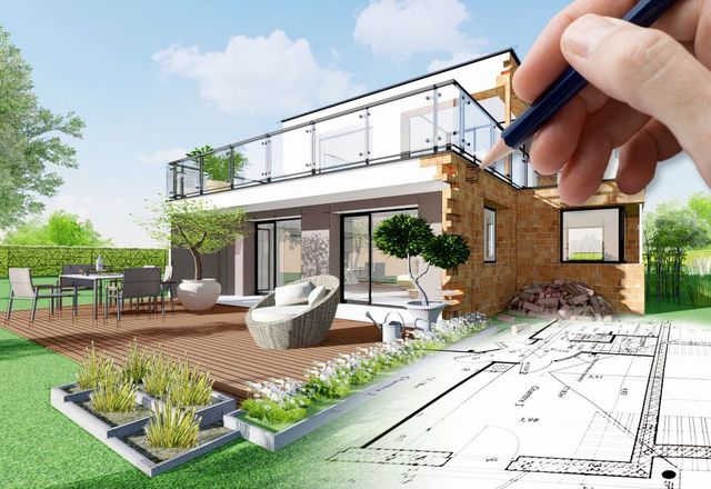 A person is drawing a house on a blueprint with a pencil.